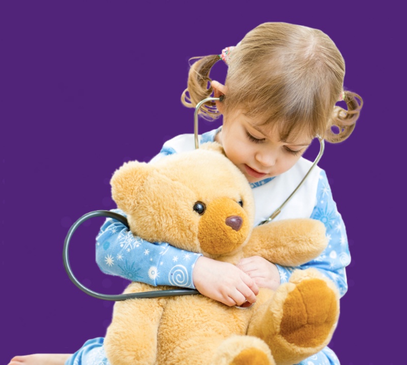 girl with stethoscope and teddy bear