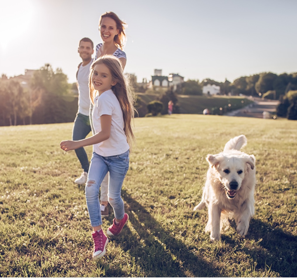 smiling family running through park