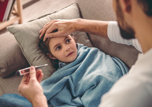 father taking child's temperature