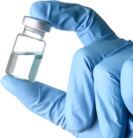 gloved hand holding a vaccine vial